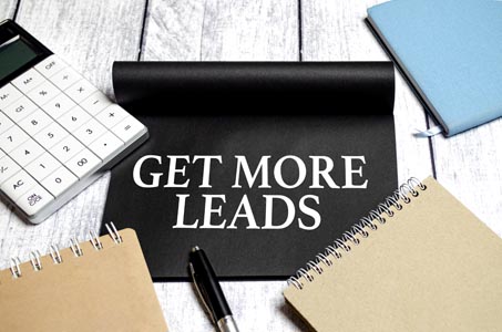 Get More Leads text as memo on notebook with pen with R54Media