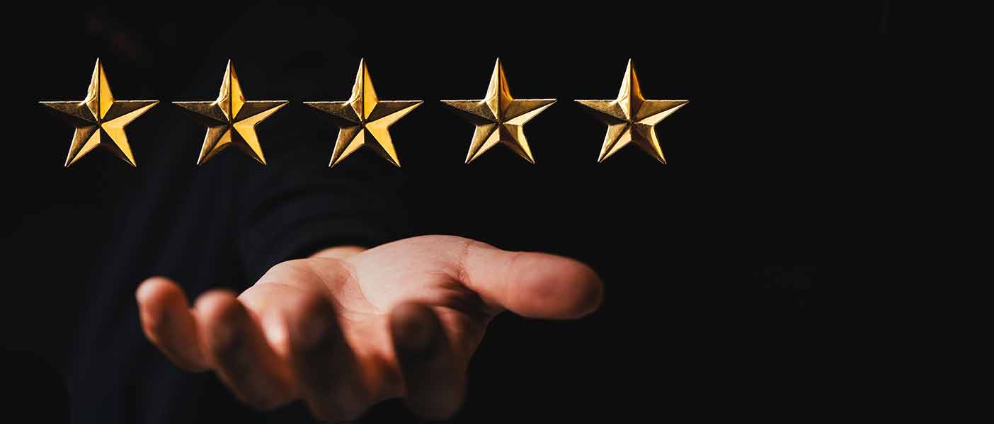 golden star rating on hand in dark background,rating