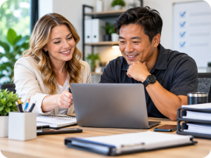 Two business professionals reviewing customer information and planning follow-up activities using a laptop.
